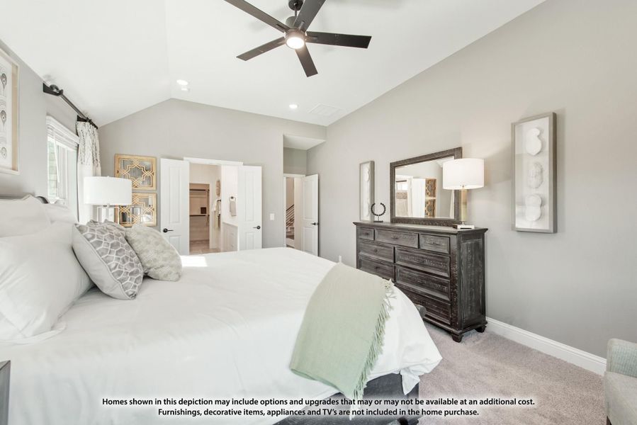 Master bedroom with vaulted ceiling, ceiling fan, dark wood dresser, and carpet flooring Master bedroom with vaulted ceiling, ceiling fan, dark wood dresser, and carpet flooring