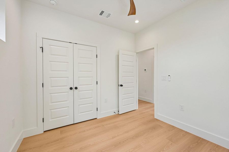 Blonde wood flooring and bright white walls create a serene, airy atmosphere in this versatile interior space. Blonde wood flooring and bright white walls create a serene, airy atmosphere in this versatile interior space.