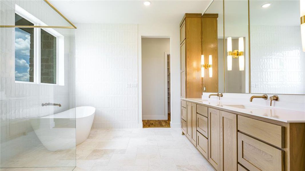 Bathroom featuring double sink, oversized vanity, tile walls, and tile floors