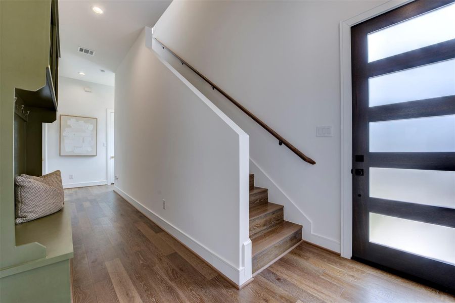 Front door and gorgeous entry with staircase on the first floor.