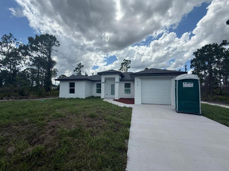 Front exterior of a new home in , Lehigh Acres, FL, highlighting curb appeal (Image 14). Front exterior of a new home in , Lehigh Acres, FL, highlighting curb appeal (Image 14).