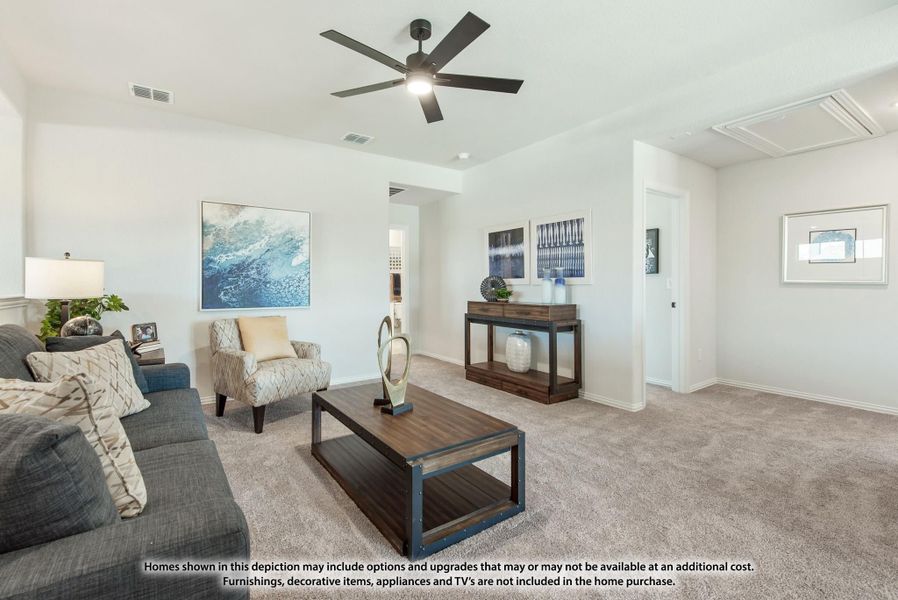 Living room with gray sofa, ceiling fan, carpet flooring, and wood coffee table