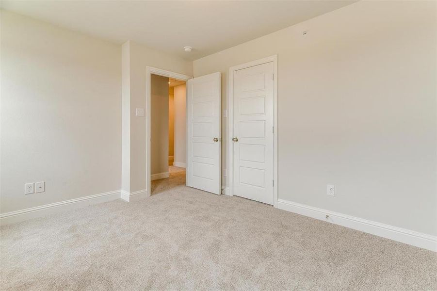 Unfurnished bedroom featuring light carpet