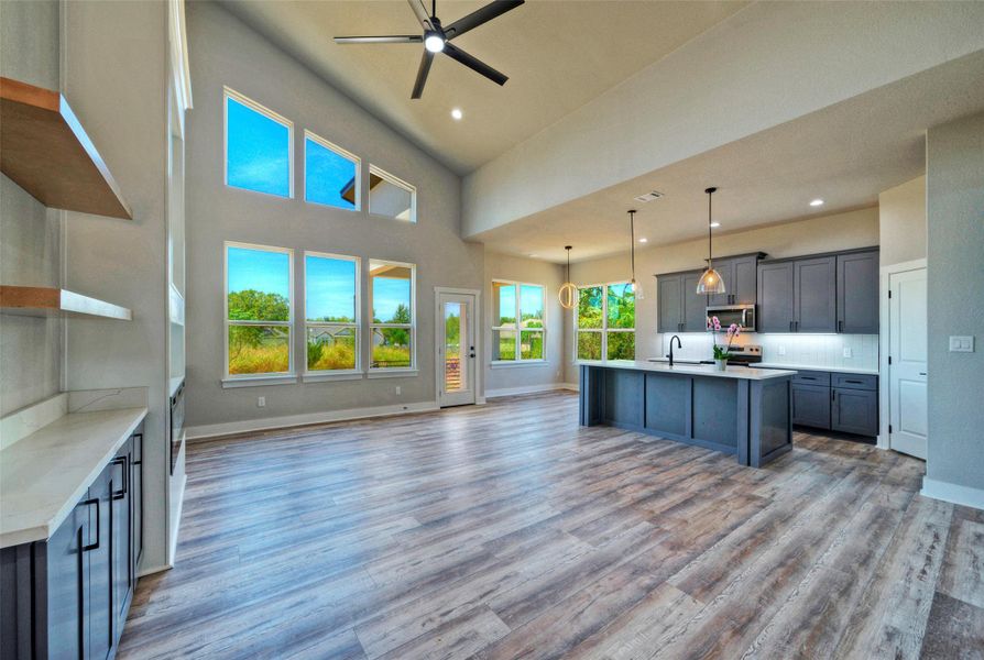 High vaulted ceilings and wood floors define this expansive open concept kitchen and living area. High vaulted ceilings and wood floors define this expansive open concept kitchen and living area.