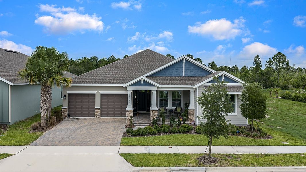 Front exterior of a new home in Harvest at Ovation, Winter Garden, FL, highlighting curb appeal (Image 23). Front exterior of a new home in Harvest at Ovation, Winter Garden, FL, highlighting curb appeal (Image 23).