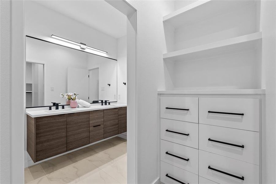Full bath with double vanity and light marble finish floors Full bath with double vanity and light marble finish floors