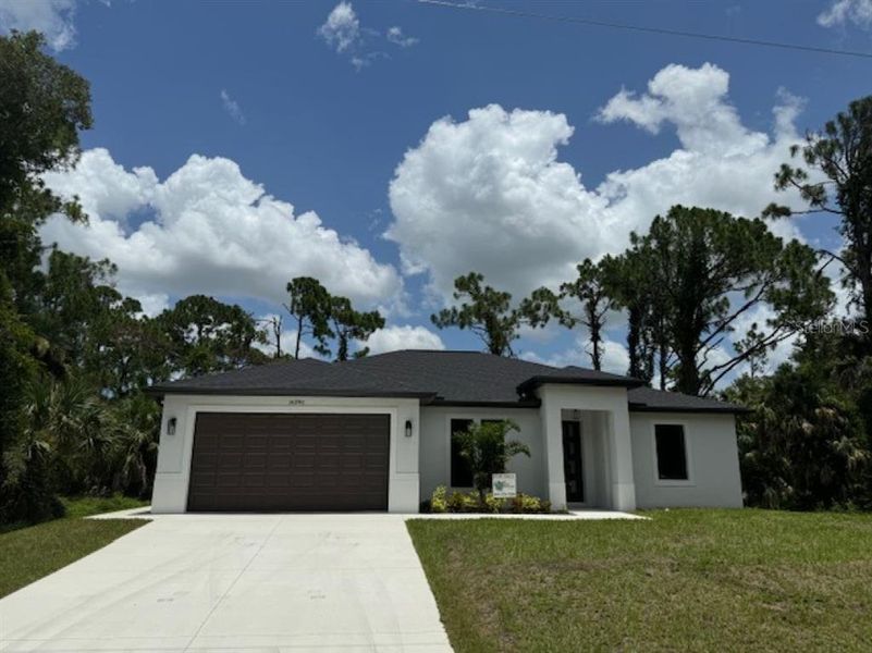 Front exterior of a new home in , Port Charlotte, FL, highlighting curb appeal (Image 1).