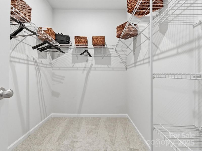 Oversized Primary Walk-In Closet. *Model Photos | Actual Finishes, Structural Selections, and Orientation May Vary.