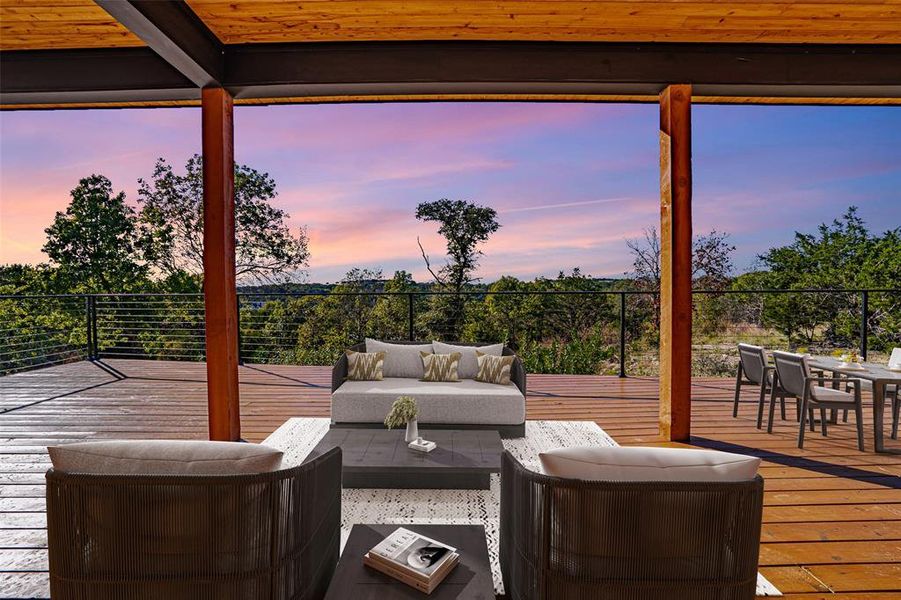 Deck at dusk featuring an outdoor hangout area and outdoor dining area Deck at dusk featuring an outdoor hangout area and outdoor dining area