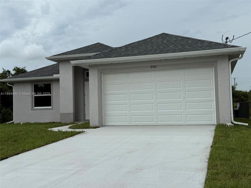 Front exterior of a new home in , Lehigh Acres, FL, highlighting curb appeal (Image 1). Front exterior of a new home in , Lehigh Acres, FL, highlighting curb appeal (Image 1).