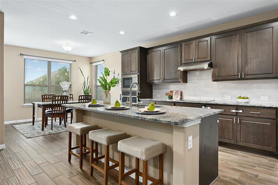 Wonderful large kitchen island that serves multiple purposes.