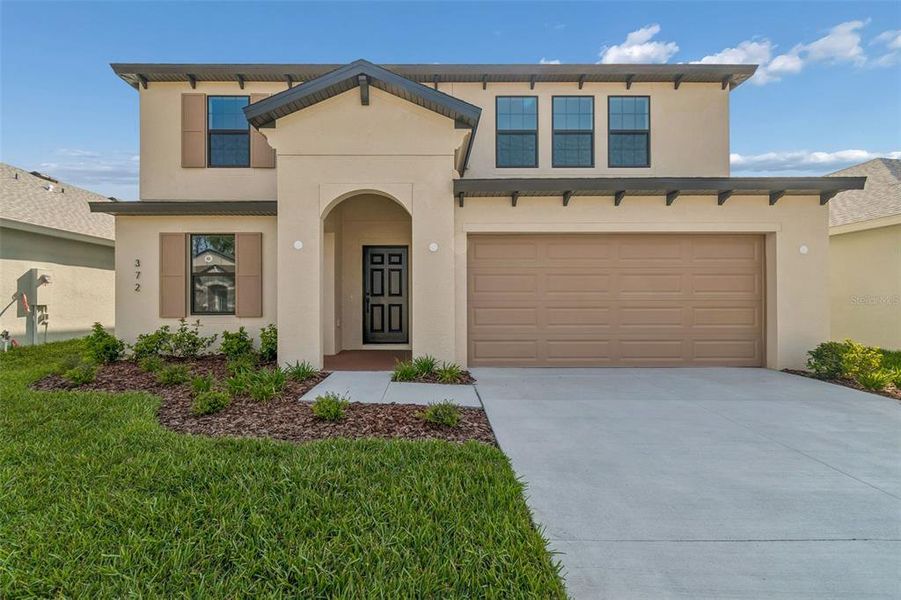 Front exterior of a new home in Avalon West, Spring Hill, FL, highlighting curb appeal (Image 28).