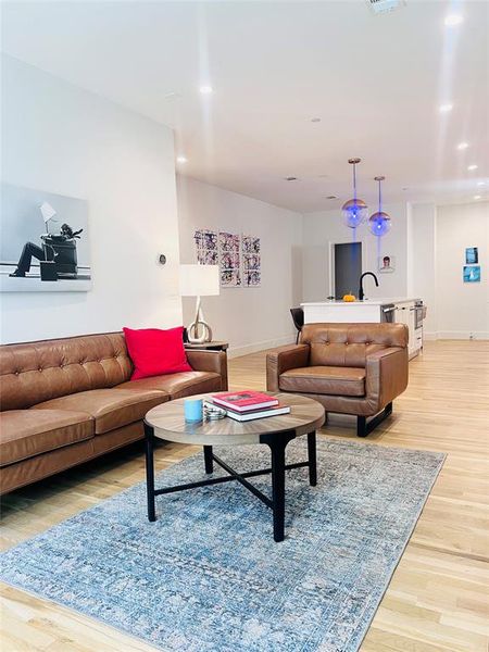 Living area featuring light wood-type flooring and recessed lighting Living area featuring light wood-type flooring and recessed lighting
