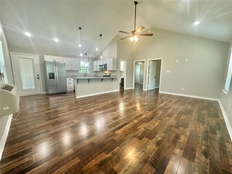 Upstairs Living room with luxury vinyl plank floors, ceiling fan, high vaulted ceiling, and recessed lighting Upstairs Living room with luxury vinyl plank floors, ceiling fan, high vaulted ceiling, and recessed lighting
