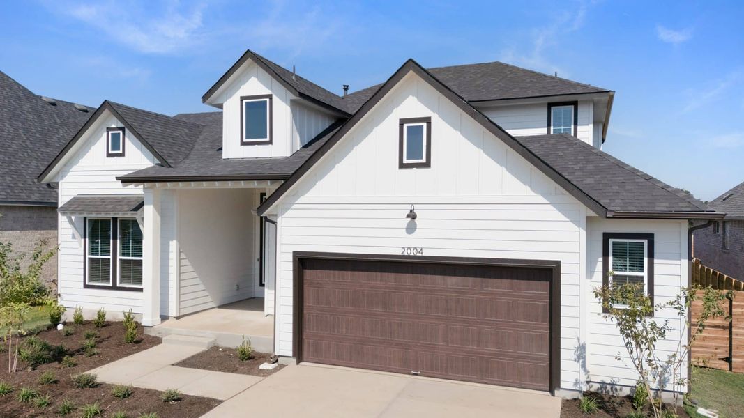Front exterior of a new home in Broken Oak, Georgetown, TX, highlighting curb appeal (Image 15). Front exterior of a new home in Broken Oak, Georgetown, TX, highlighting curb appeal (Image 15).