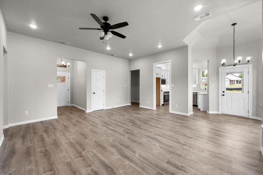 Open-concept living space featuring wood-finish flooring, recessed lighting, and a contemporary ceiling fan