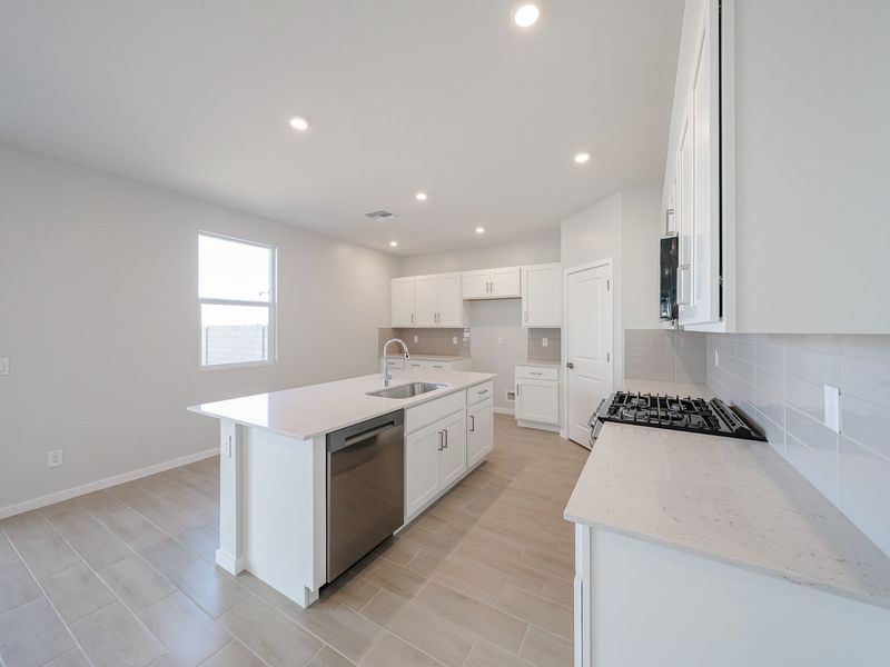A kitchen with white cabinets.