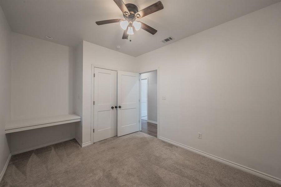 Unfurnished bedroom with carpet floors and ceiling fan Unfurnished bedroom with carpet floors and ceiling fan