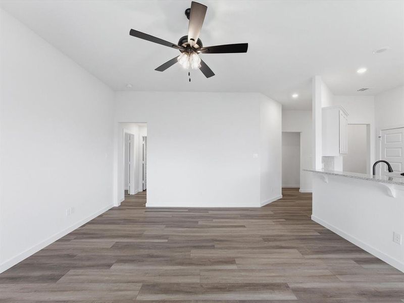 Open concept living area with wood-finish flooring Open concept living area with wood-finish flooring