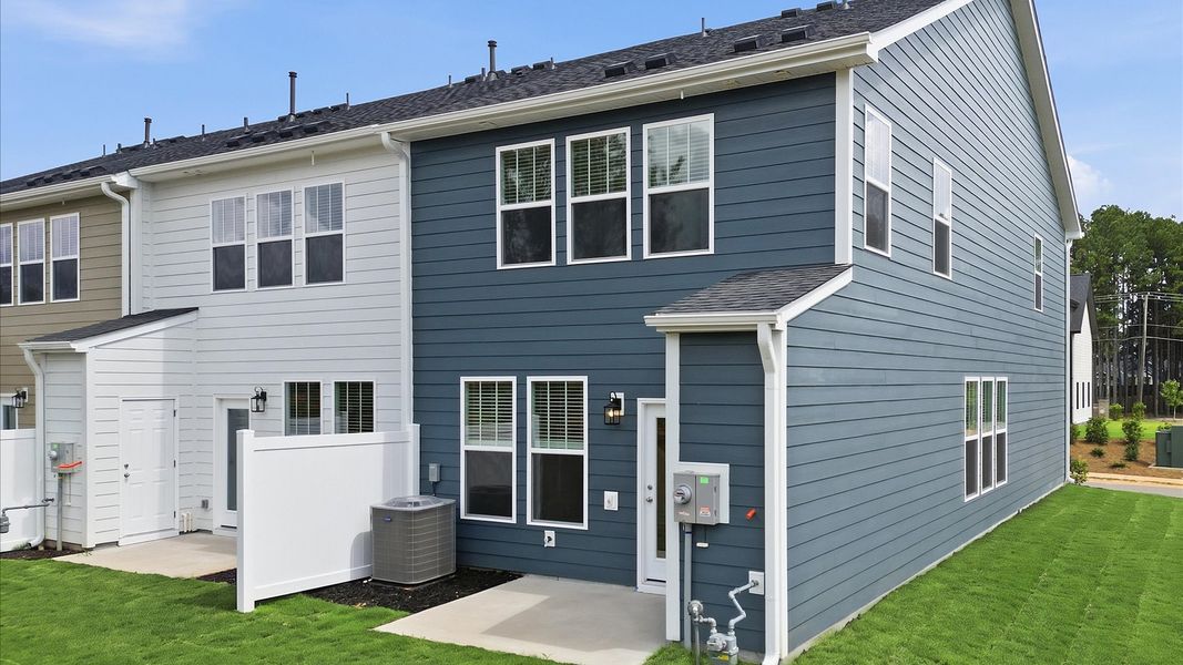 Vibrant rear outdoor space featuring a patio and exceptional craftsmanship near Downtown Fountain Inn