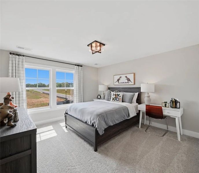A well-lit bedroom features plush carpeting and br A well-lit bedroom features plush carpeting and br