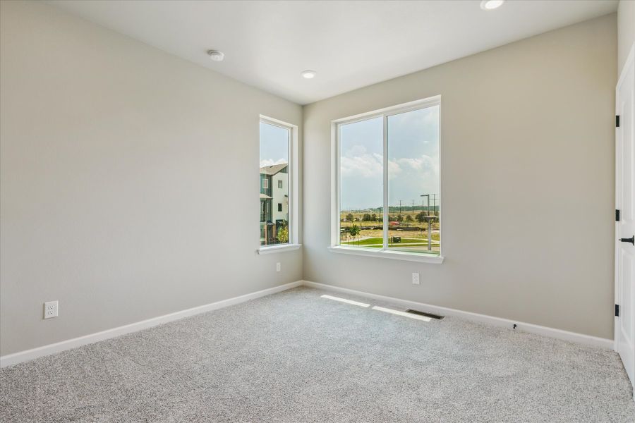 A room with a window and a carpet.