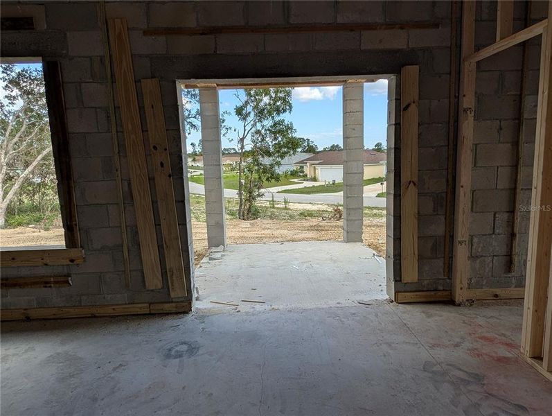 VIEW LOOKING OUT YOUR SLIDING GLASS DOORS THAT LEAD OUT ONTO YOUR COVERED BACK PATIO