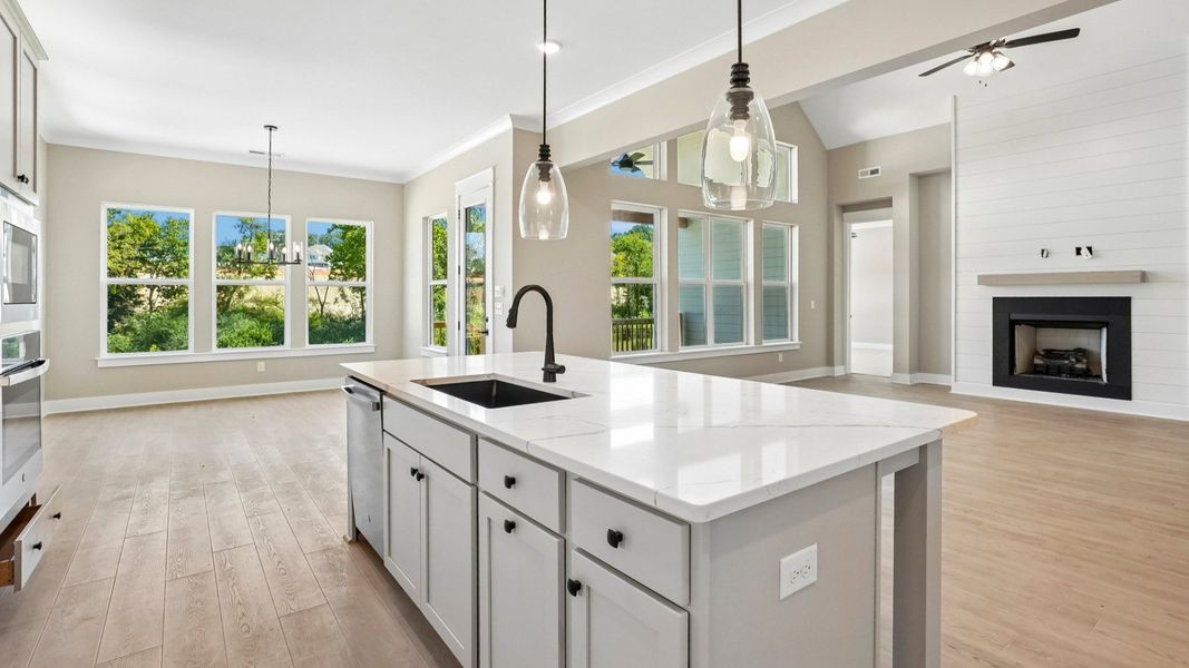Kitchen with island paired with sink and dishwasher Kitchen with island paired with sink and dishwasher