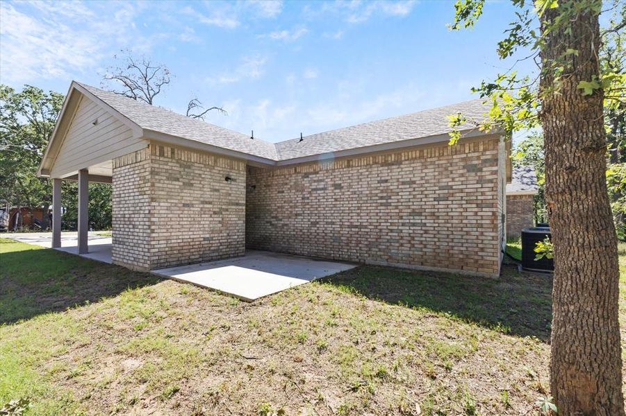 Rear view of house featuring central AC, a lawn, and a patio area