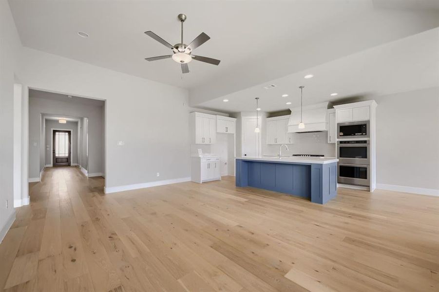 Open-concept living space featuring wood-finish flooring