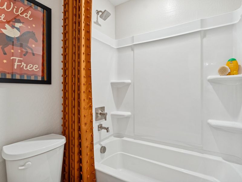 A bathroom with a toilet and bathtub. A bathroom with a toilet and bathtub.