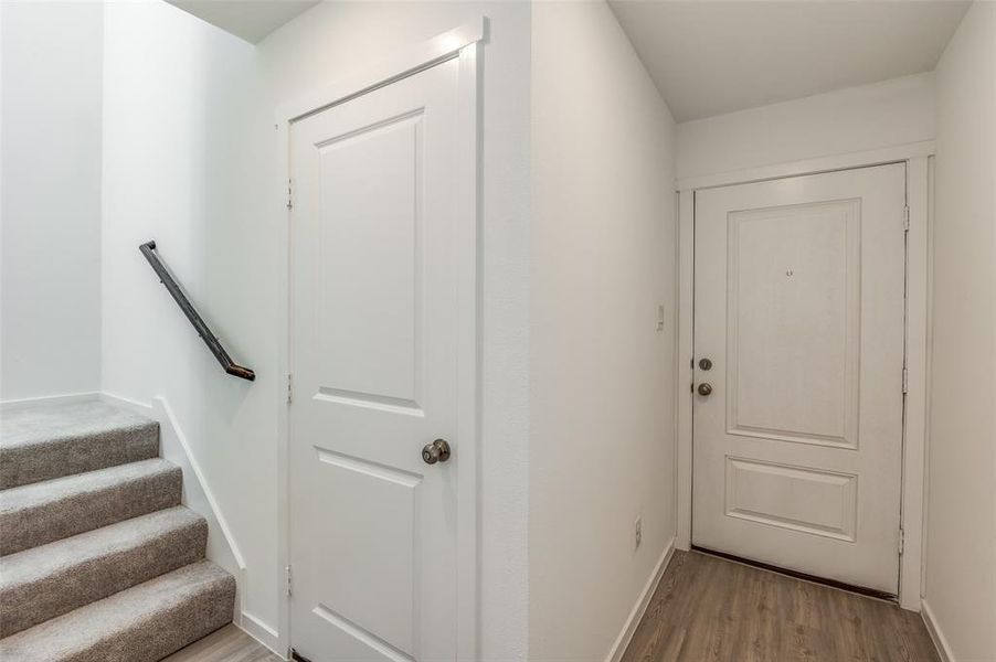 Doorway with light hardwood / wood-style floors