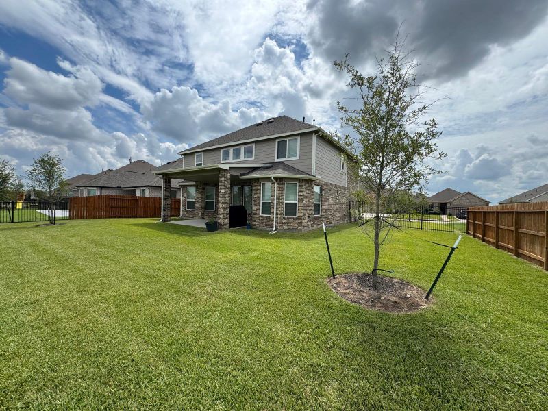 Front exterior of a new home in Rodeo Palms - The Lakes, Manvel, TX, highlighting curb appeal (Image 22). Front exterior of a new home in Rodeo Palms - The Lakes, Manvel, TX, highlighting curb appeal (Image 22).
