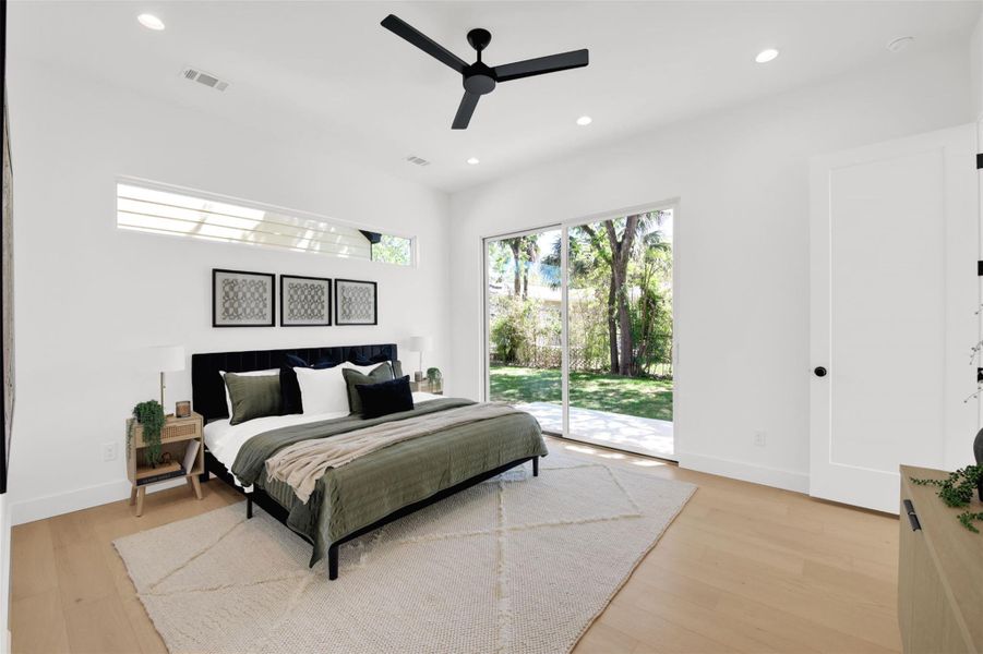 Primary bedroom featuring access to outside, recessed lighting, ceiling fan, and light wood-type flooring