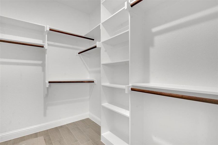 Spacious closet with wood tiled floors Spacious closet with wood tiled floors