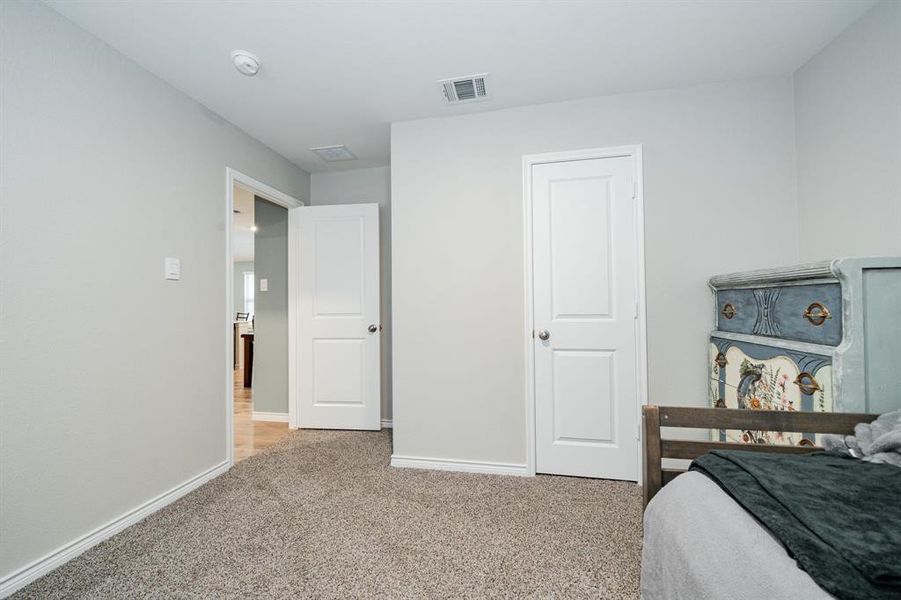 Bedroom with light colored carpet and baseboards Bedroom with light colored carpet and baseboards