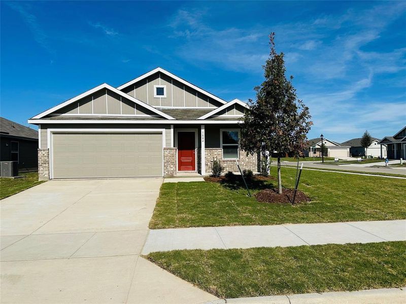 Craftsman-style house with a garage and a front lawn