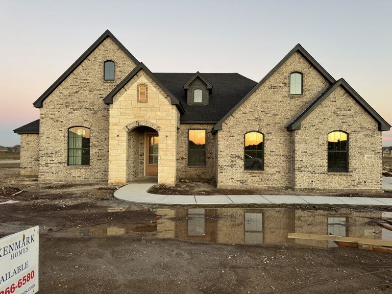 Front exterior of a new home in Coyote Crossing, Godley, TX, highlighting curb appeal (Image 1).