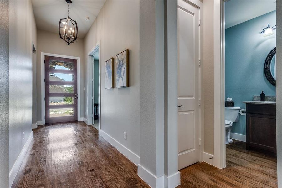 Gleaming handscraped hardwood floors greet you at the front door