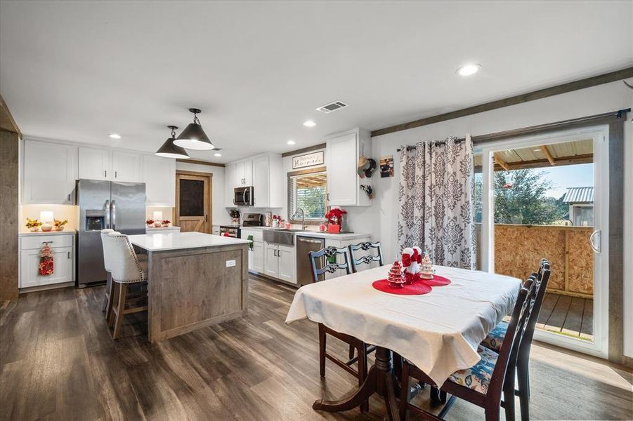 Dining room with dark wood-type flooring and recessed lighting Dining room with dark wood-type flooring and recessed lighting