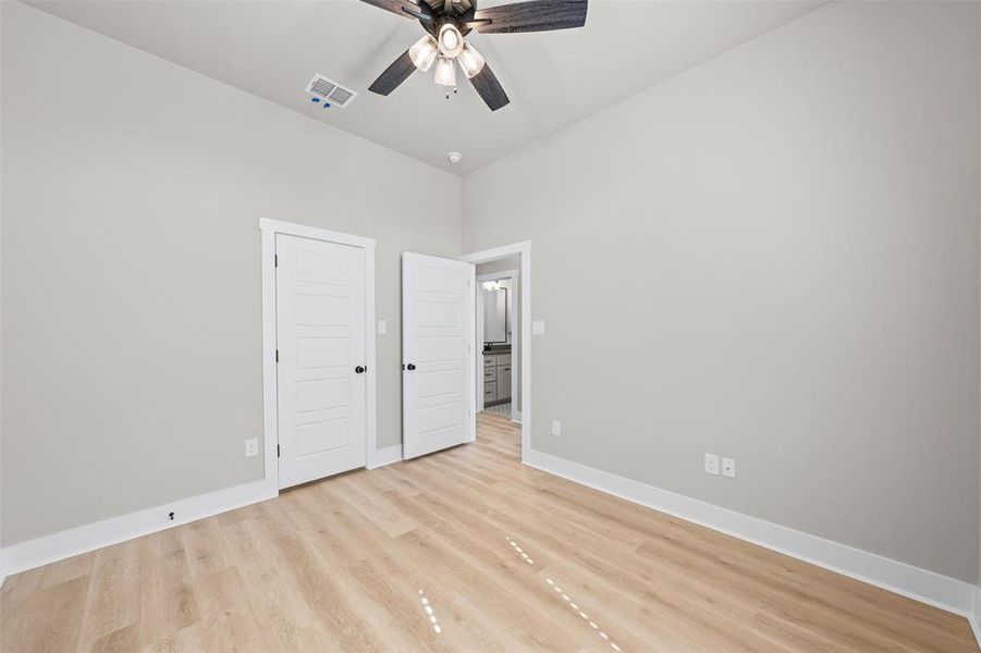 Unfurnished bedroom featuring light wood-style floors, ceiling fan, and a closet Unfurnished bedroom featuring light wood-style floors, ceiling fan, and a closet