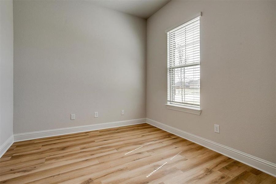 Empty room featuring light hardwood / wood-style flooring and a healthy amount of sunlight