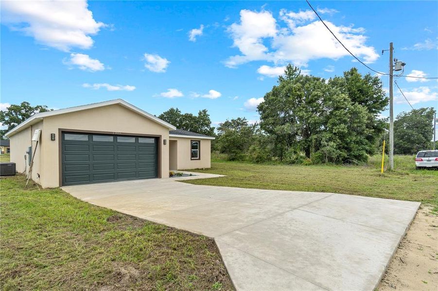 Front exterior of a new home in , Dunnellon, FL, highlighting curb appeal (Image 17).