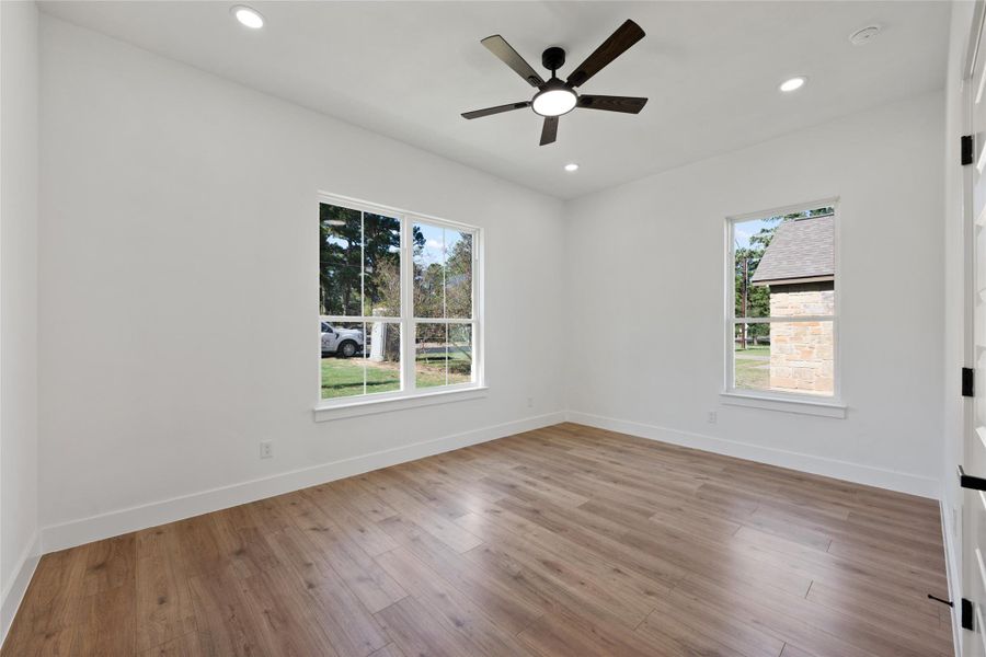 Empty room with light wood-type flooring, recessed lighting, and ceiling fan