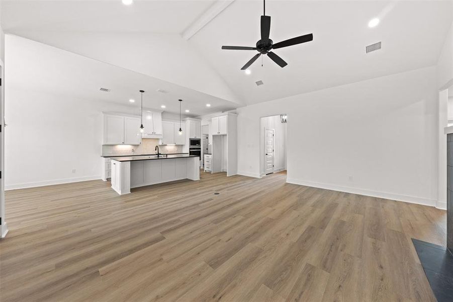 Unfurnished living room with a ceiling fan, light wood-style flooring, and recessed lighting