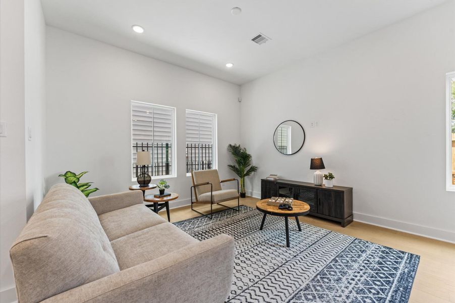 This welcoming living area blends comfort and style with an open layout and abundant natural light. Large windows create a bright, airy atmosphere, while neutral tones and warm finishes set a relaxing mood. Whether you're hosting guests or enjoying a quiet evening, the space offers flexible seating and a seamless connection to adjacent rooms—perfect for modern living. This welcoming living area blends comfort and style with an open layout and abundant natural light. Large windows create a bright, airy atmosphere, while neutral tones and warm finishes set a relaxing mood. Whether you're hosting guests or enjoying a quiet evening, the space offers flexible seating and a seamless connection to adjacent rooms—perfect for modern living.