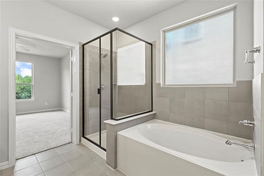 Bathroom with plus walk in shower and tile patterned floors