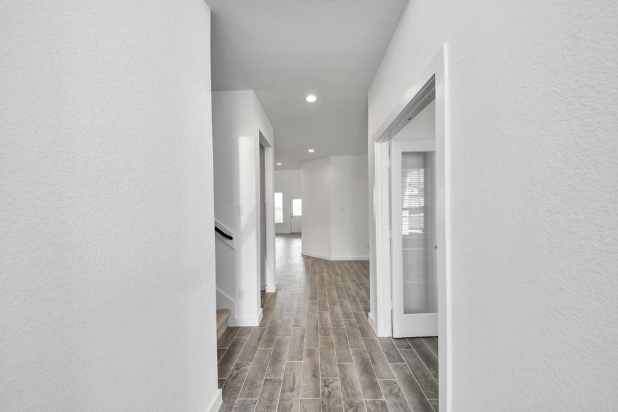As you step into the threshold of this luxurious home, you'll soon be welcomed by an elegant glass door (to be installed). Inside, soaring ceilings amplify the spaciousness, while the refined wood-look tile flooring and oversized baseboards exude sophistication and charm. As you step into the threshold of this luxurious home, you'll soon be welcomed by an elegant glass door (to be installed). Inside, soaring ceilings amplify the spaciousness, while the refined wood-look tile flooring and oversized baseboards exude sophistication and charm.