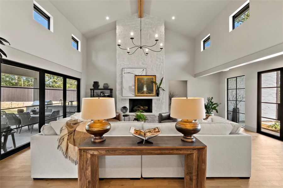 Open, vaulted living area with large heavly smeard stone fireplace.
