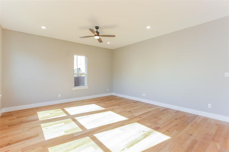 Spare room featuring ceiling fan and light wood-type flooring